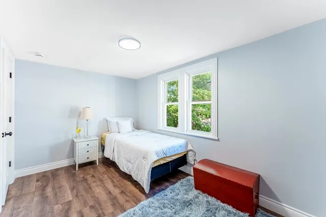 a bedroom with a bed and window