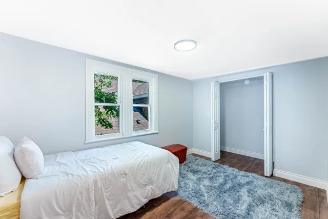 a bed room with a bed and a window