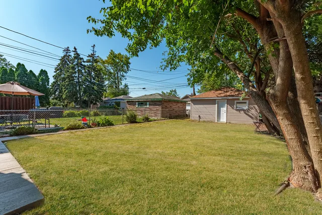 a front view of house with yard and trees