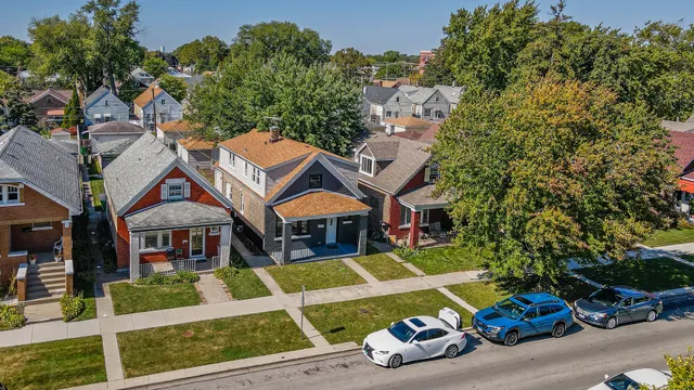 an aerial view of a houses with yard
