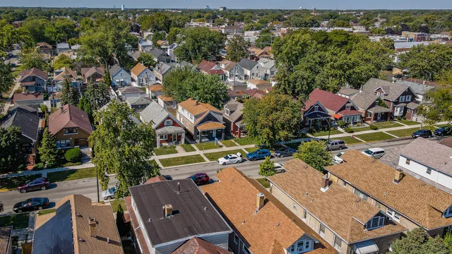 an aerial view of a houses with a yard