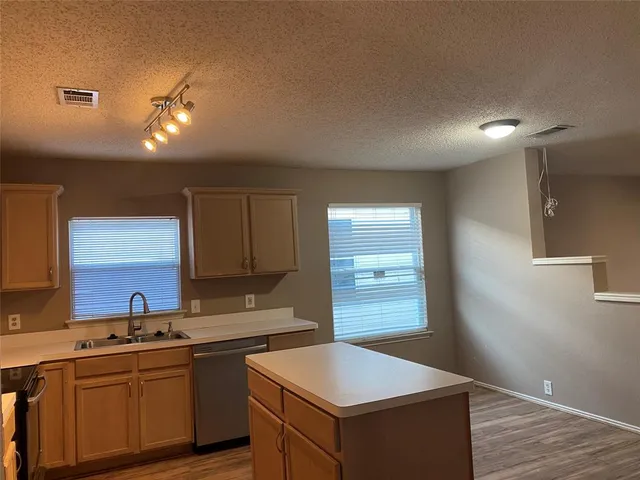 a kitchen that has a sink and a stove in it