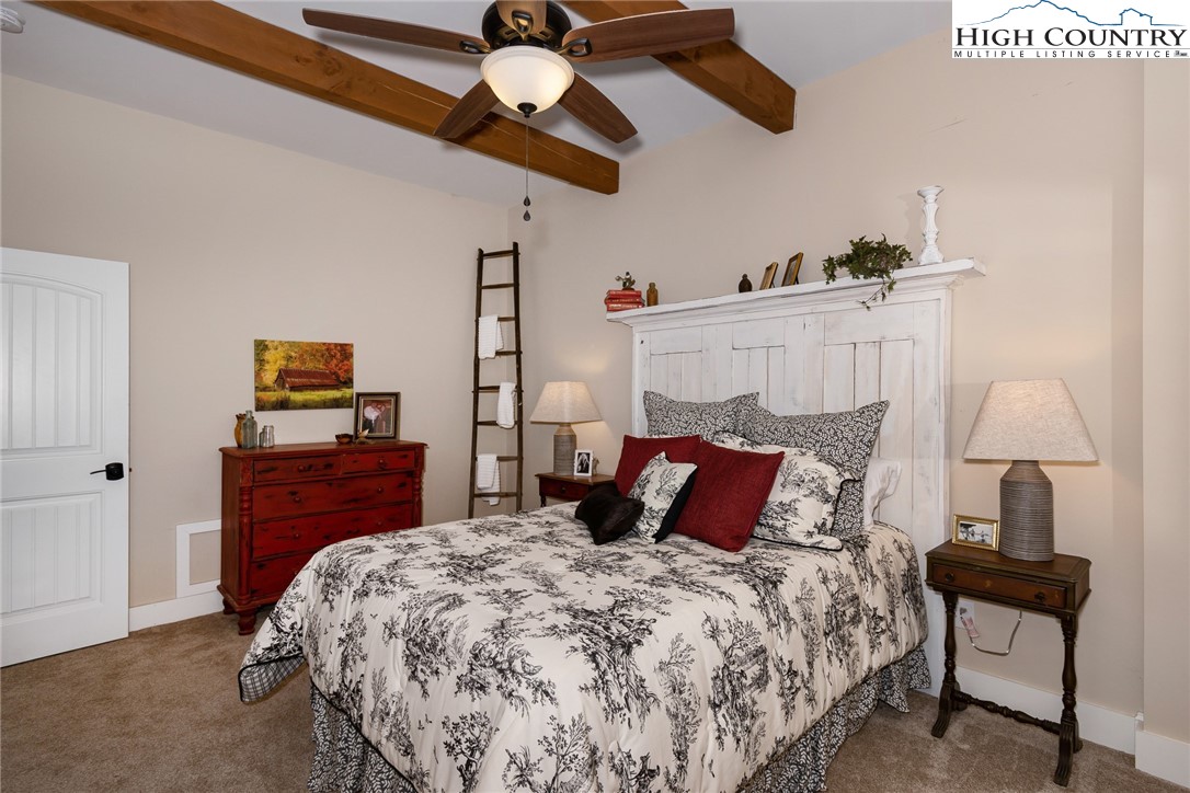 2709 Buckeye Road Elk Park, NC 28622 - Photo 27 of 43 a bedroom with a bed and wooden floor