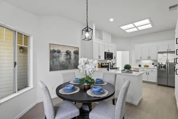 a dining room with furniture and window