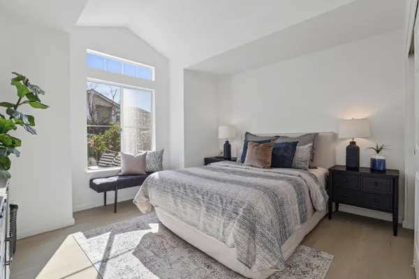 a bedroom with a bed and a chair