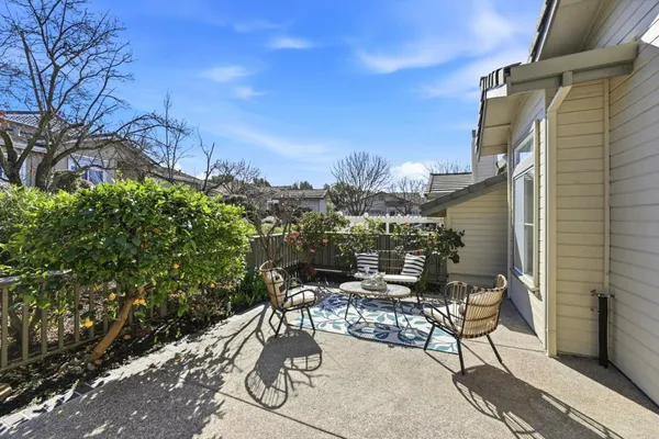 a view of a patio with table and chairs and potted plants