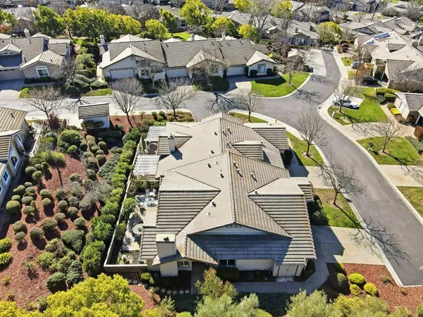 an aerial view of a house with garden space and street view