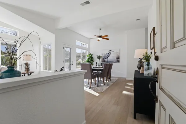 a living room with furniture a table and chairs