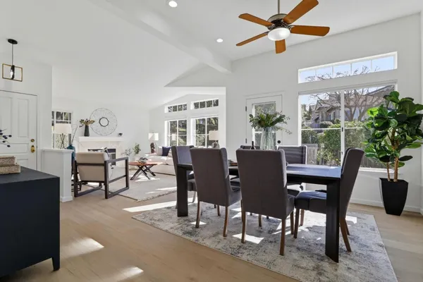 a dining room with furniture a window and wooden floor