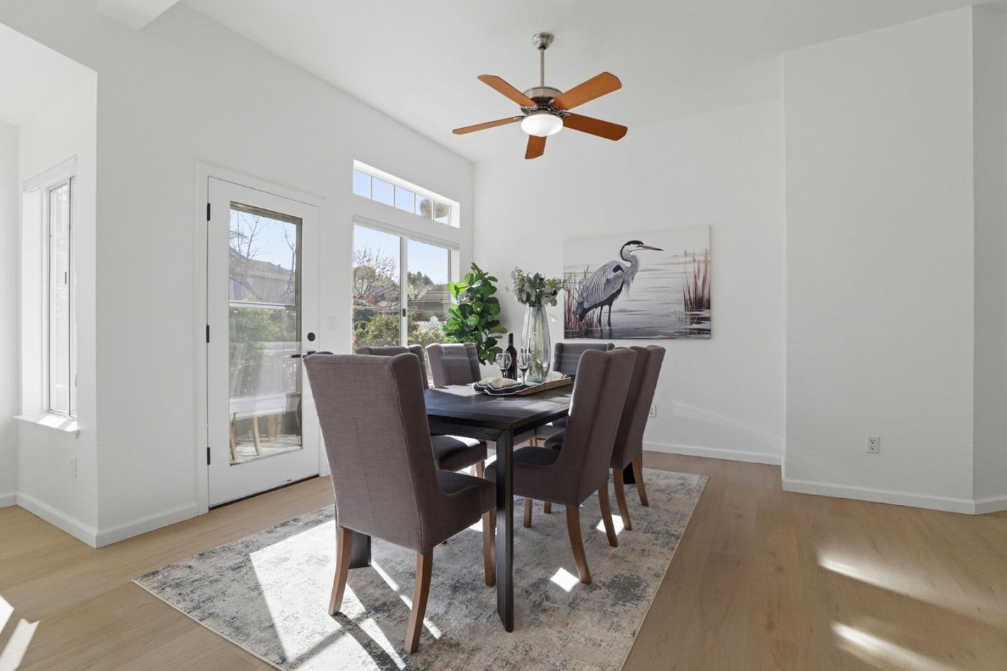 8611 Vineyard Ridge Place San Jose, CA 95135 - Photo 7 of 49 a dining room with furniture a window and wooden floor
