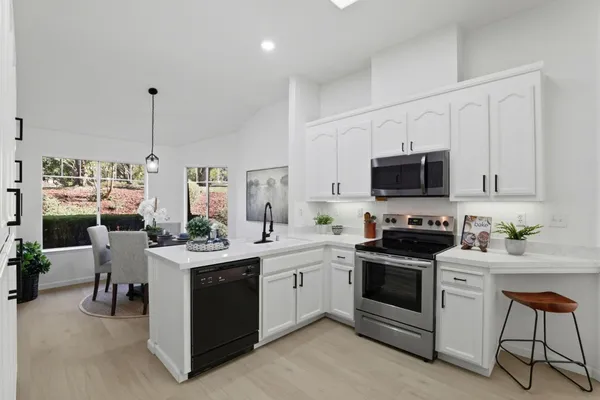 a kitchen with refrigerator a microwave and cabinets