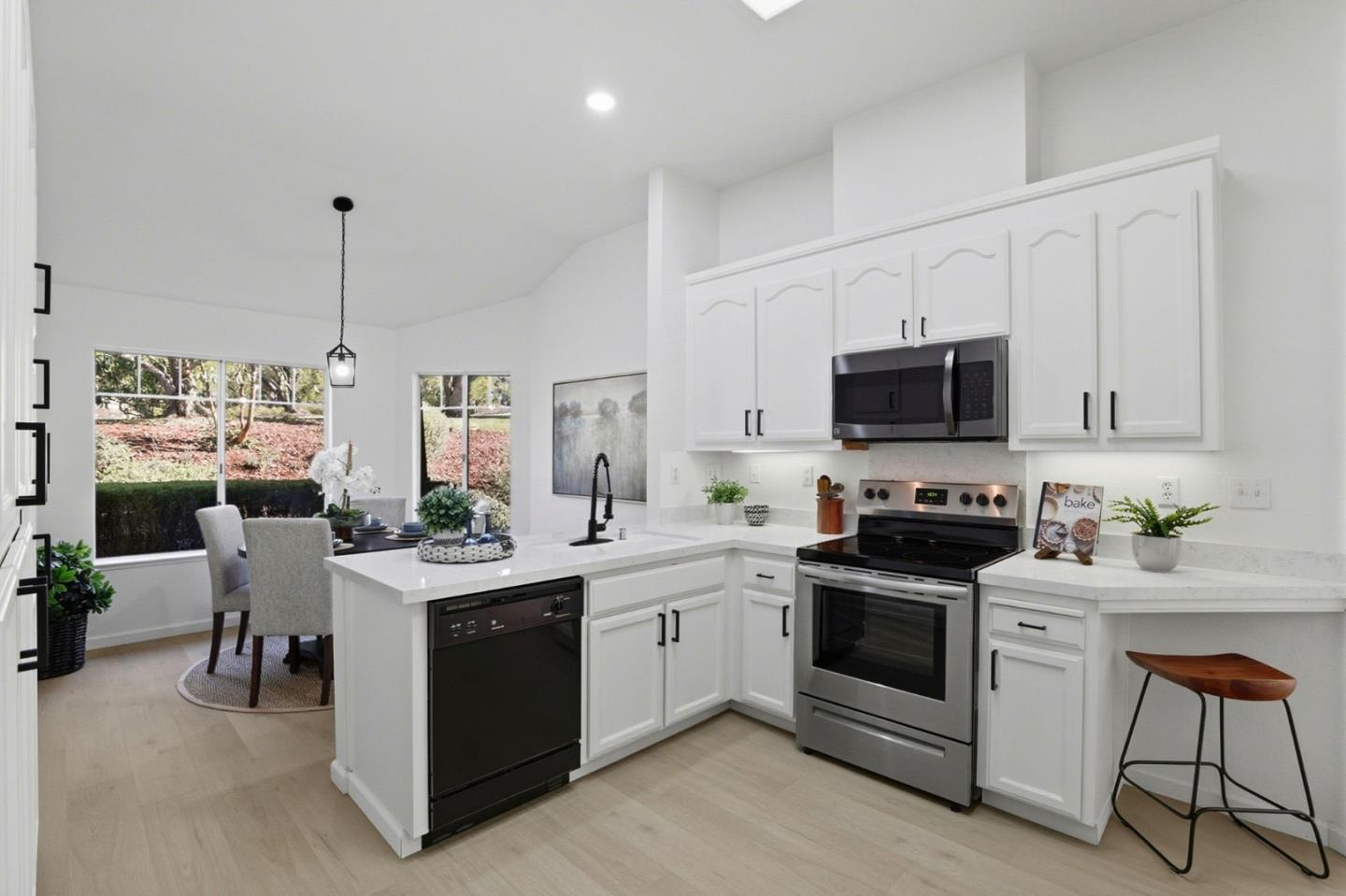 8611 Vineyard Ridge Place San Jose, CA 95135 - Photo 8 of 49 a kitchen with white cabinets and white appliances