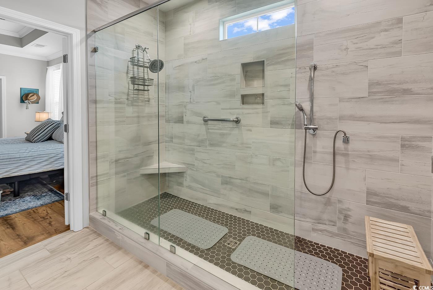 6024 Curran Street Murrells Inlet, SC 29576 - Photo 18 of 34 Ensuite bathroom featuring healthy amount of natural light, ornamental molding, and a tile shower