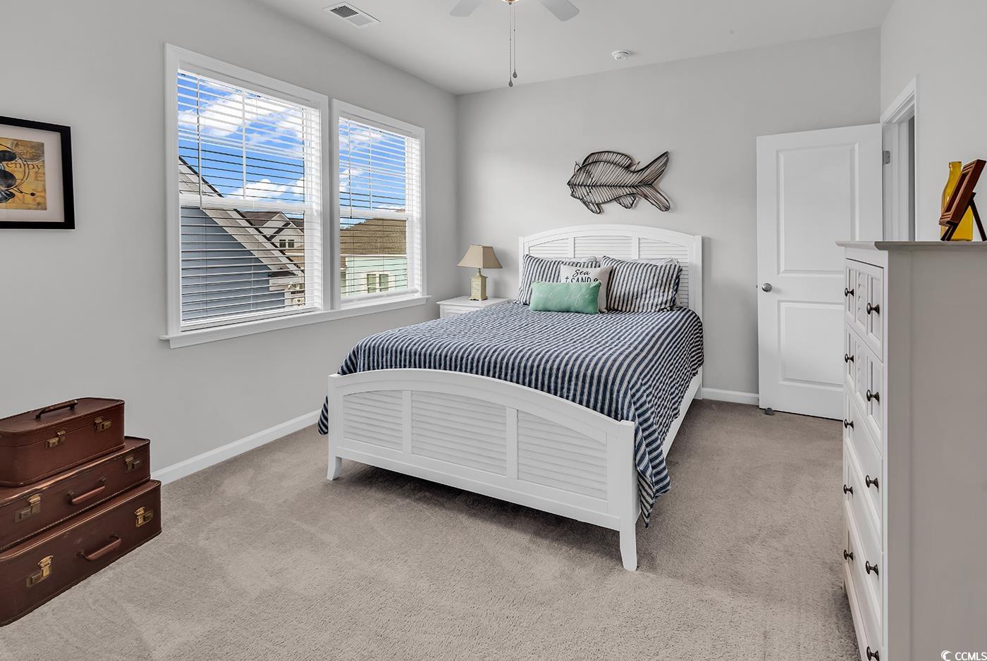 6024 Curran Street Murrells Inlet, SC 29576 - Photo 20 of 34 Bedroom with light colored carpet and ceiling fan