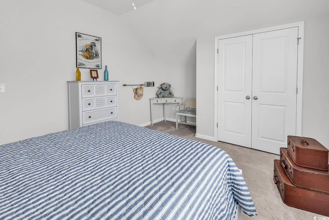 6024 Curran Street Murrells Inlet, SC 29576 - Photo 21 of 34 Bedroom featuring light colored carpet and lofted ceiling