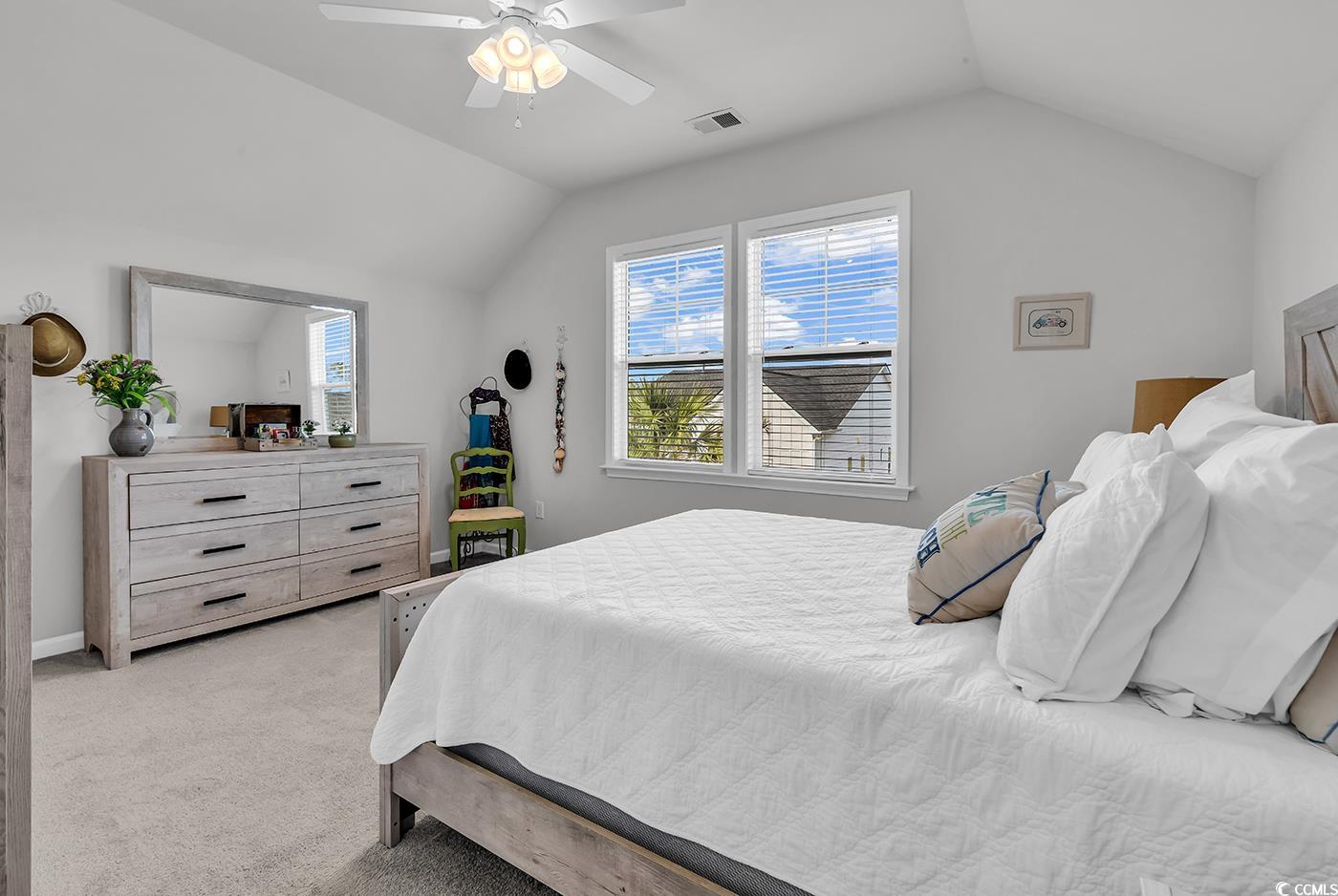 6024 Curran Street Murrells Inlet, SC 29576 - Photo 23 of 34 Bedroom featuring light carpet, vaulted ceiling, and a ceiling fan