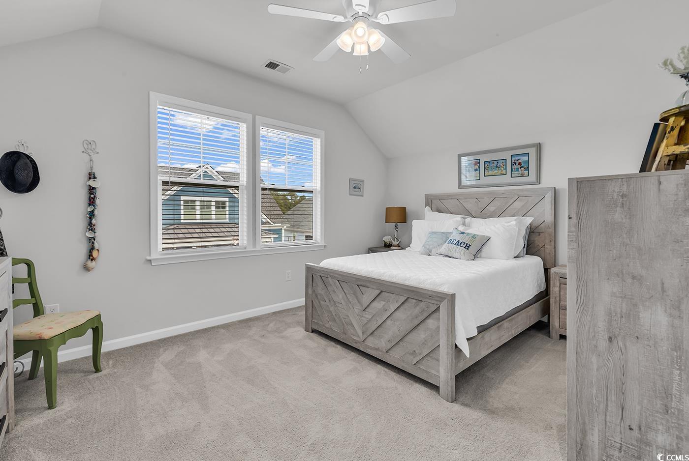 6024 Curran Street Murrells Inlet, SC 29576 - Photo 24 of 34 Bedroom with lofted ceiling, light carpet, and a ceiling fan