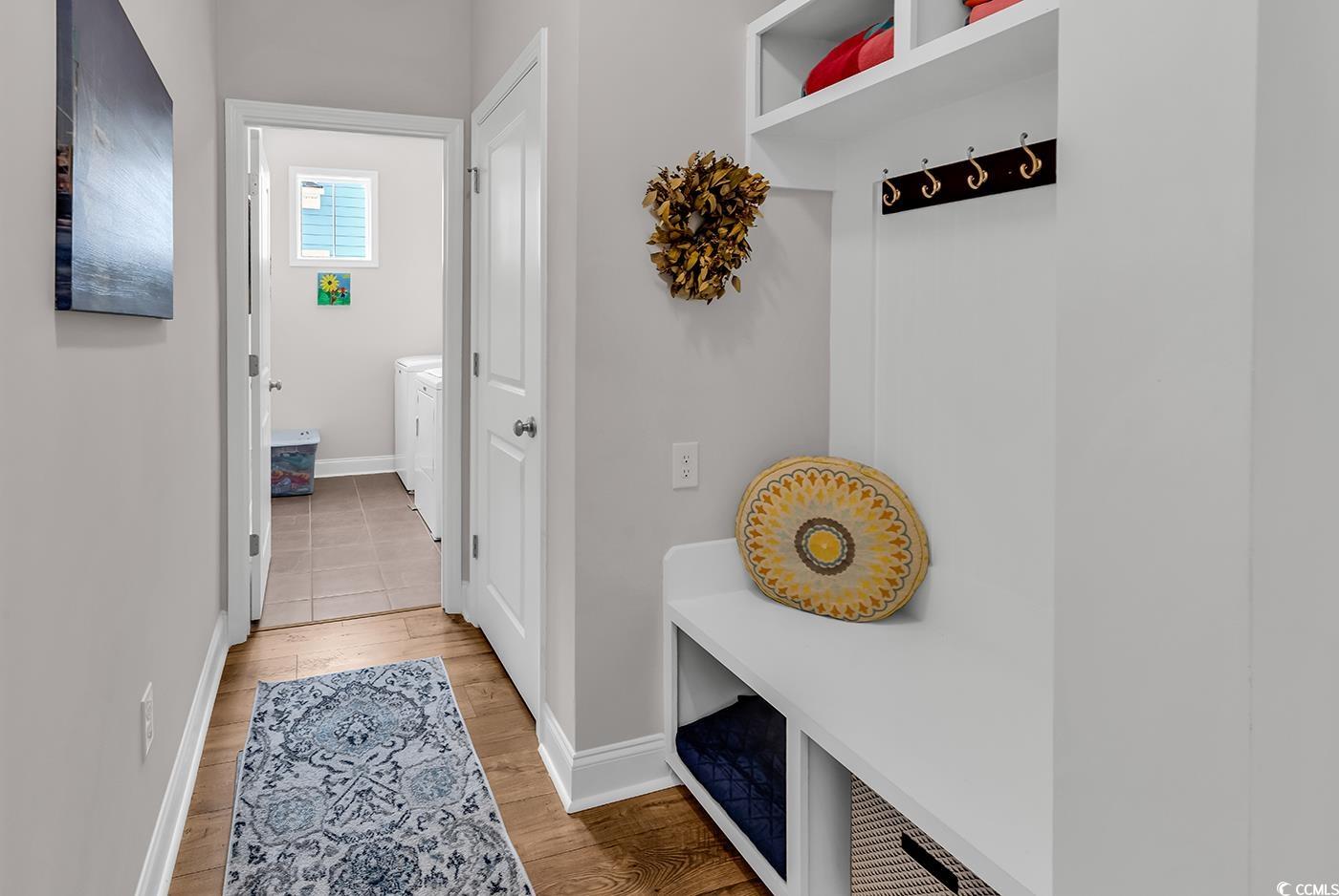 6024 Curran Street Murrells Inlet, SC 29576 - Photo 25 of 34 Mudroom featuring light wood-type flooring and washer and clothes dryer