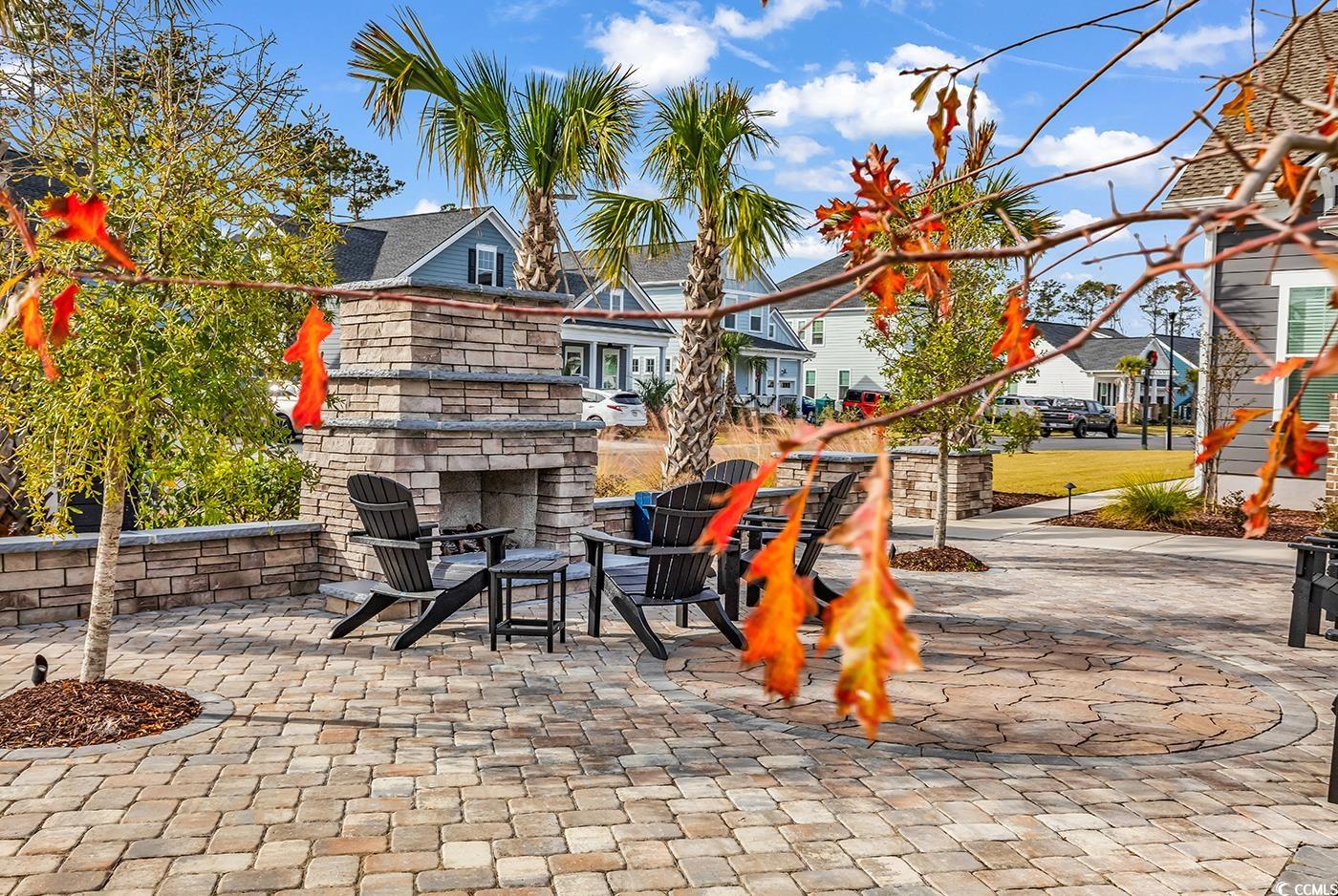 6024 Curran Street Murrells Inlet, SC 29576 - Photo 31 of 34 View of patio featuring an outdoor stone fireplace and a residential view