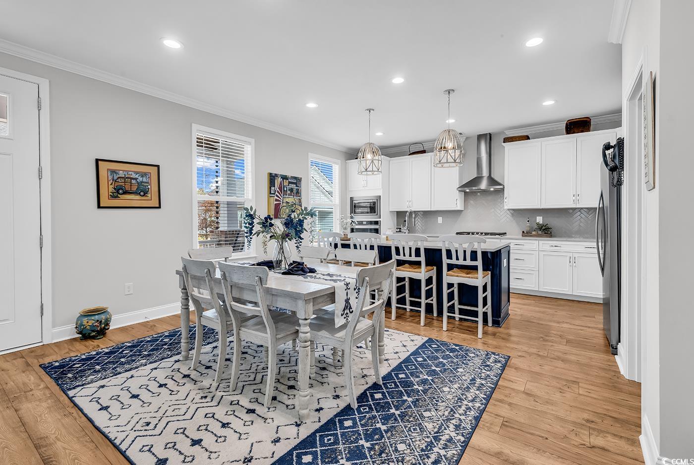 6024 Curran Street Murrells Inlet, SC 29576 - Photo 4 of 34 Dining area featuring ornamental molding, recessed lighting, and light wood finished floors