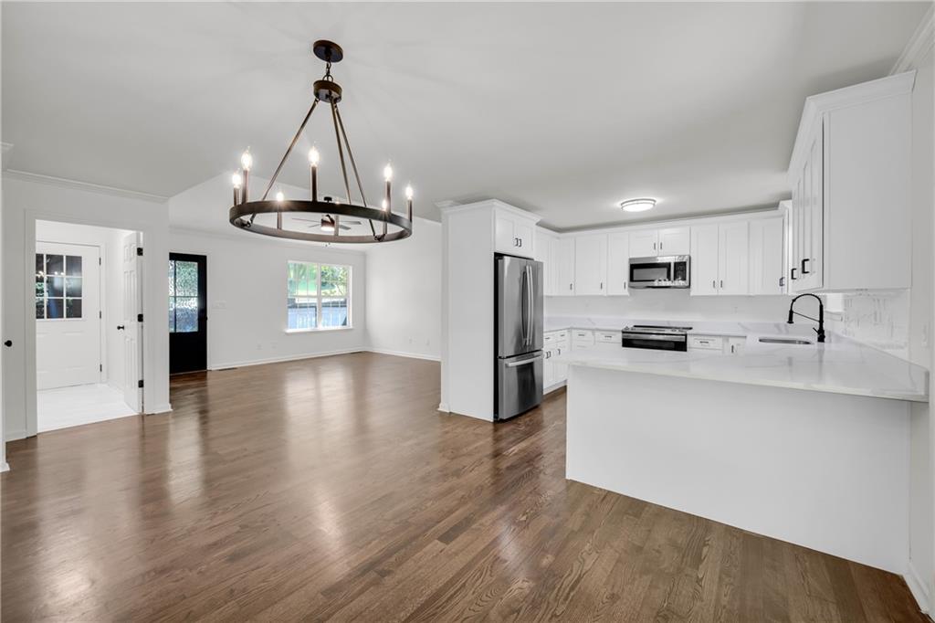 2941 Lake Hollow Road Gainesville, GA 30501 - Photo 12 of 53 a kitchen with stainless steel appliances a refrigerator and a stove top oven