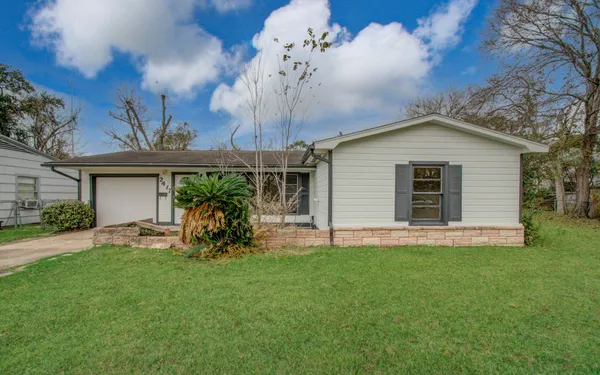 a view of a house with a yard and sitting area