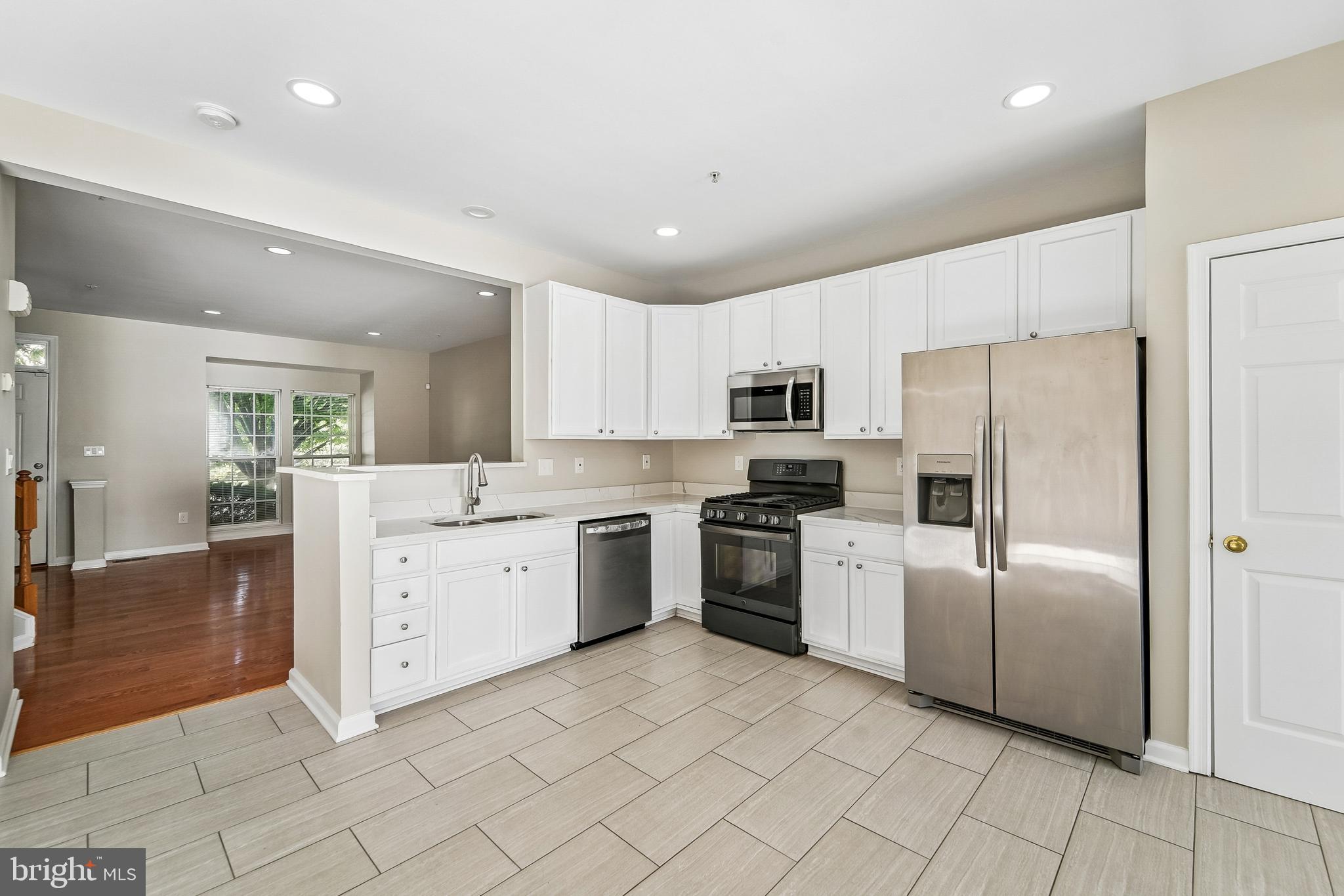 1461 Pangbourne Way Hanover, MD 21076 - Photo 18 of 51 a large white kitchen with cabinets