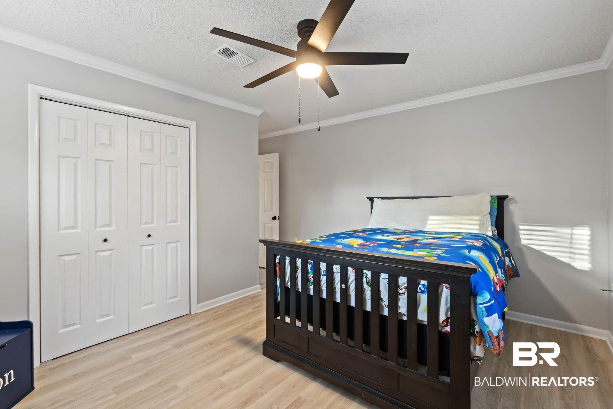 608 Southern Way Daphne, AL 36527 - Photo 28 of 35 Bedroom featuring a closet, ornamental molding, light wood finished floors, ceiling fan, and a textured ceiling
