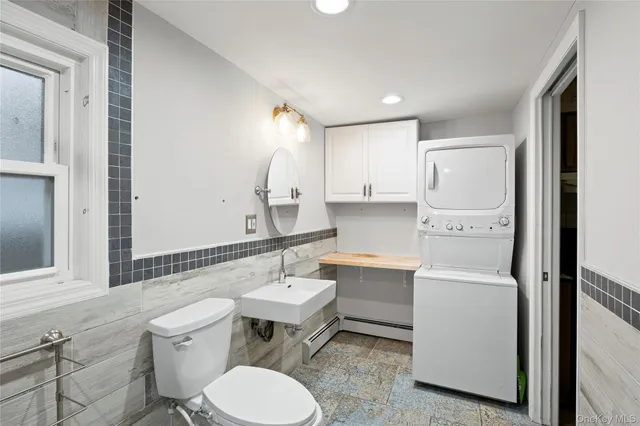 a bathroom with a sink toilet a mirror and bathtub