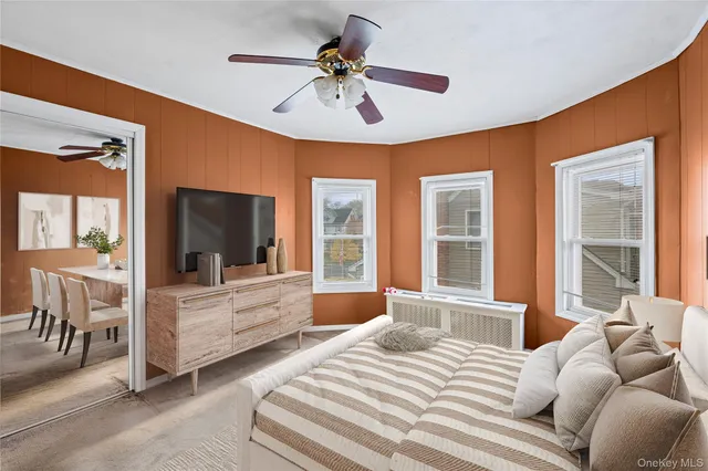 a bedroom with a bed couches and white walls