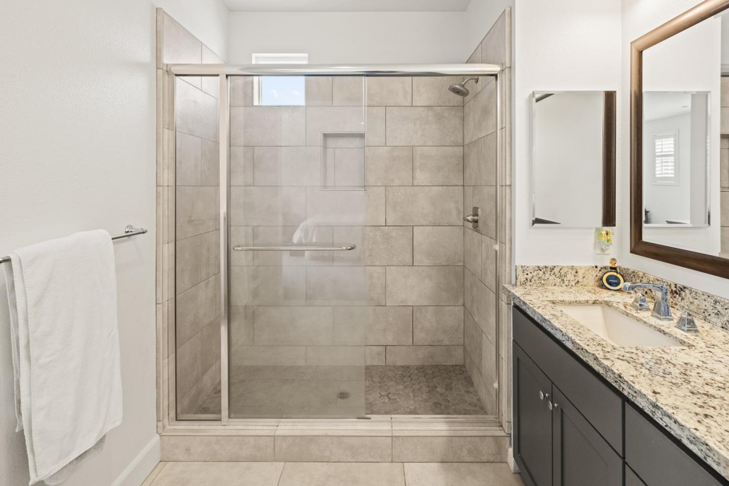 579 Rosa Monte Way Marina, CA 93933 - Photo 15 of 37 a bathroom with a granite countertop shower a sink and a mirror