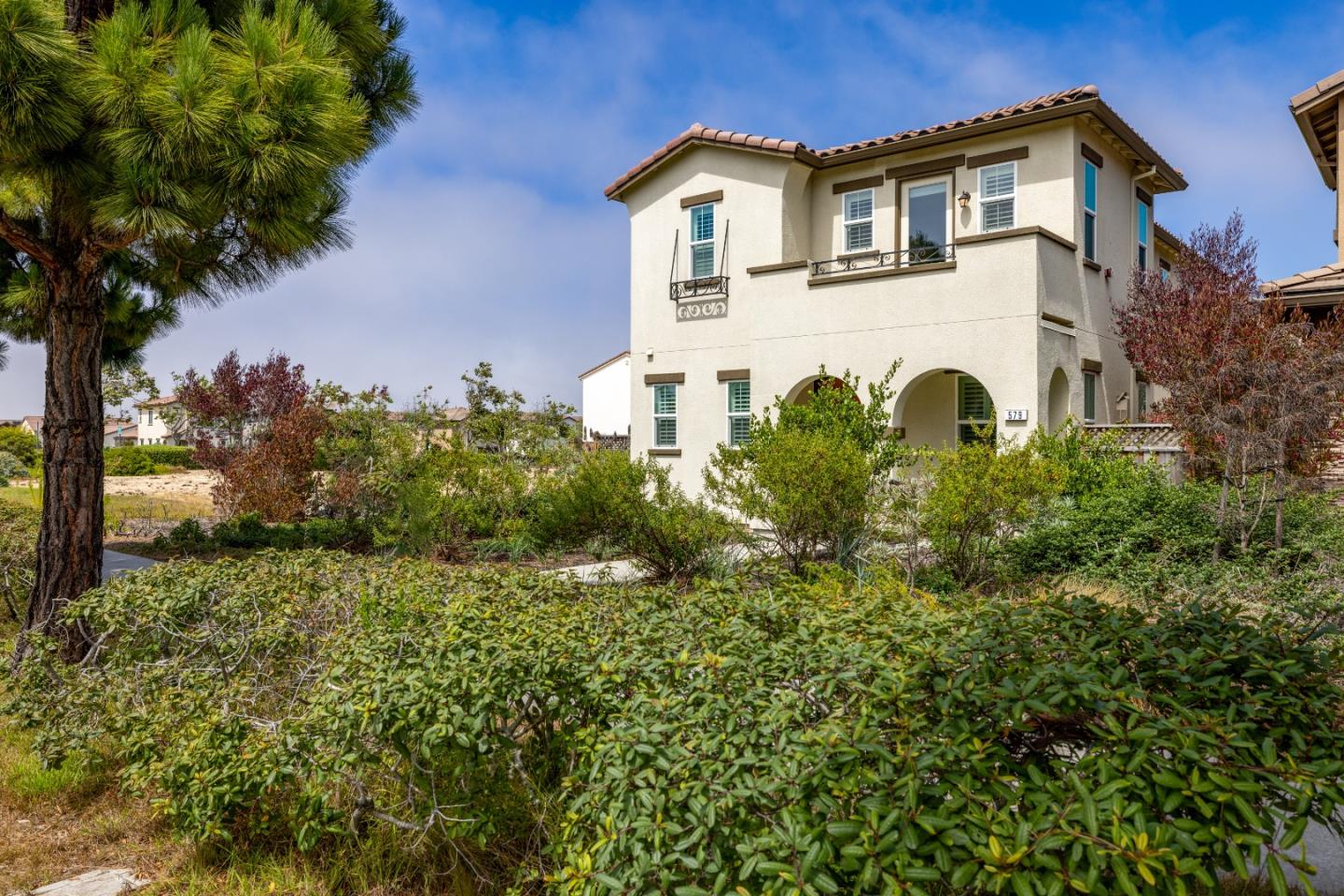 579 Rosa Monte Way Marina, CA 93933 - Photo 2 of 37 a white house with a white fence and plants