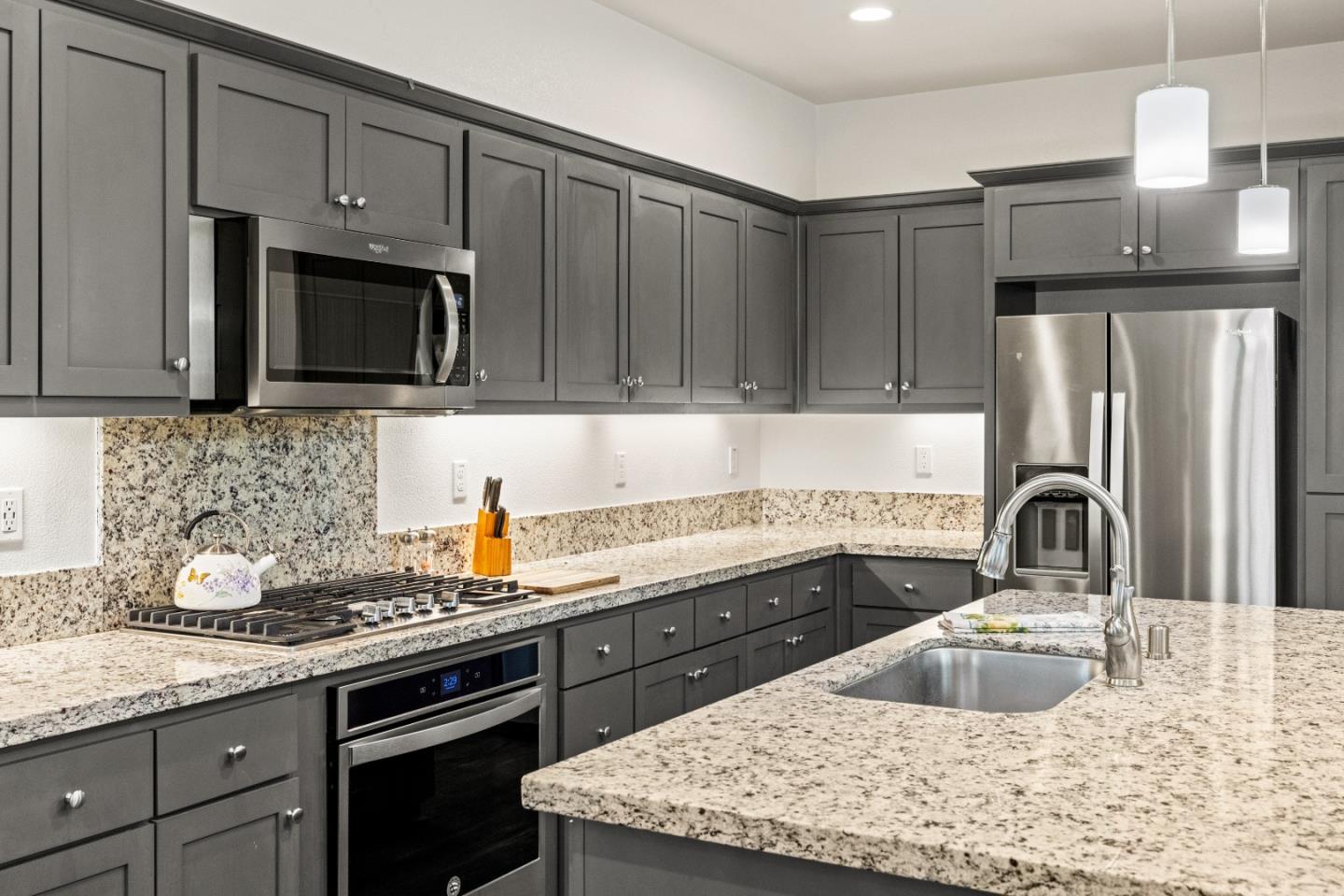579 Rosa Monte Way Marina, CA 93933 - Photo 9 of 37 a kitchen with granite countertop a sink stove and refrigerator