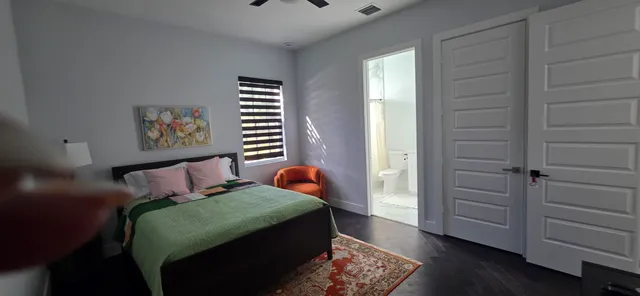 a bedroom with a bed and a window