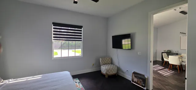 a bedroom with a bed and window