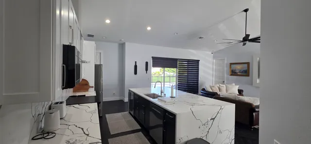 a kitchen with a sink appliances and cabinets
