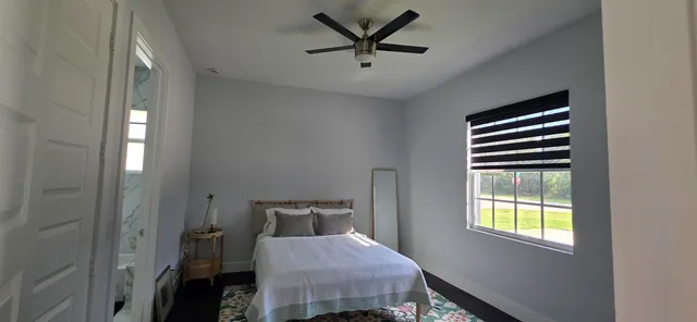 a bedroom with a bed and a window