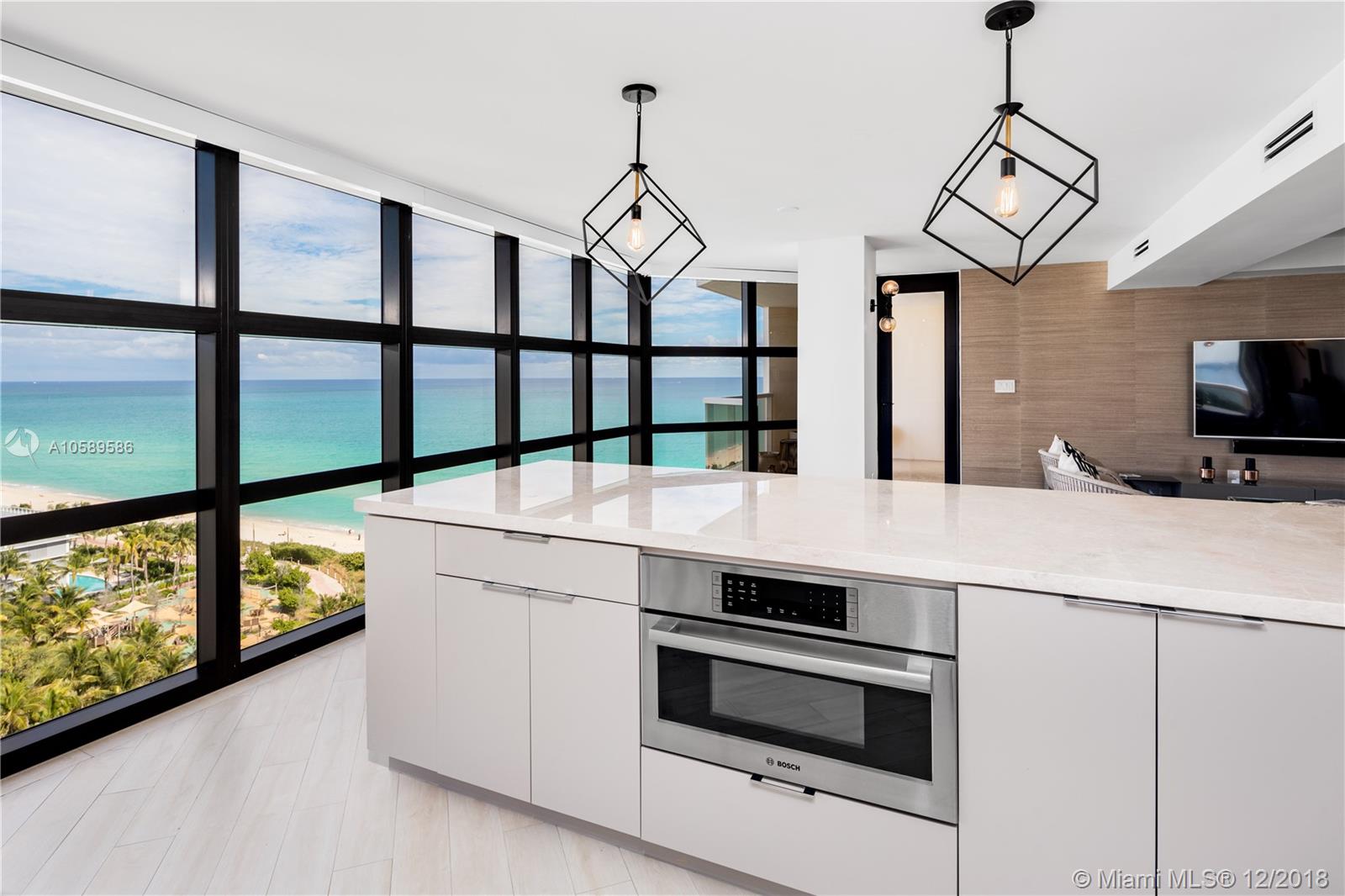 a kitchen with stainless steel appliances a stove a sink and a chandelier