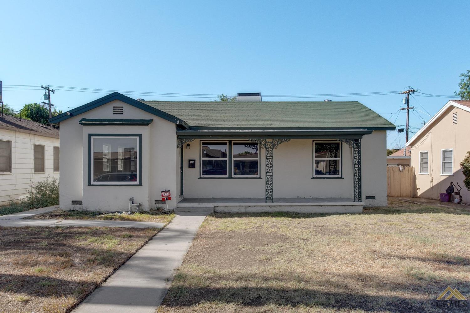 Undisclosed Address Bakersfield, CA 93305 - Photo 1 of 1 a front view of a house with a garden