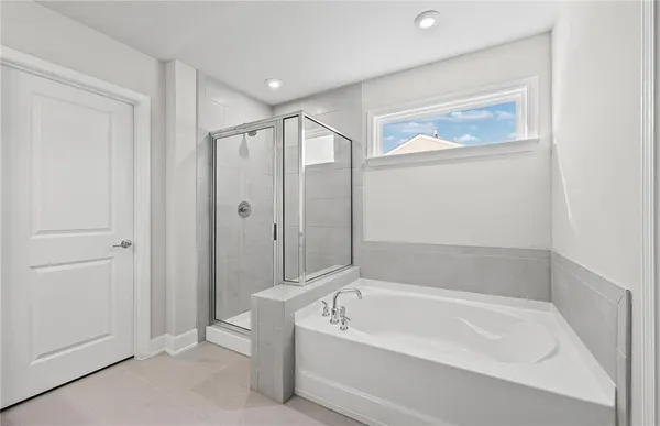 a bathroom with a bathtub and a shower