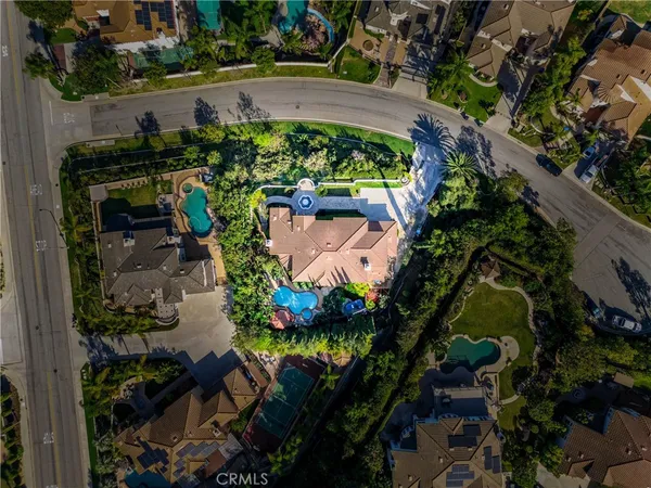 an aerial view of a house with a yard and lake view