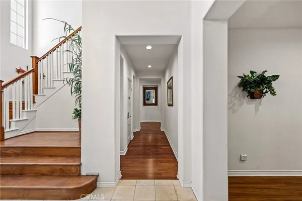 a view of entryway and hall with wooden floor