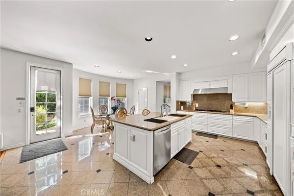 a kitchen with stainless steel appliances kitchen island granite countertop a sink and cabinets