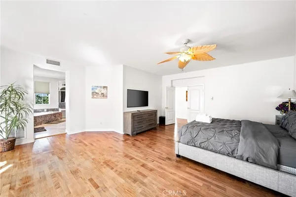 a living room with stainless steel appliances furniture a rug and a view of kitchen