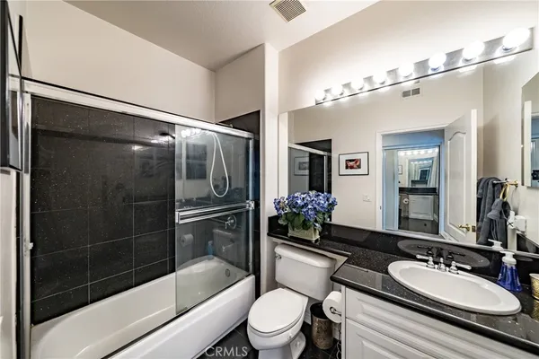 a bedroom with furniture and a wooden floor