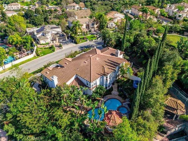 an aerial view of a house with a yard and garden
