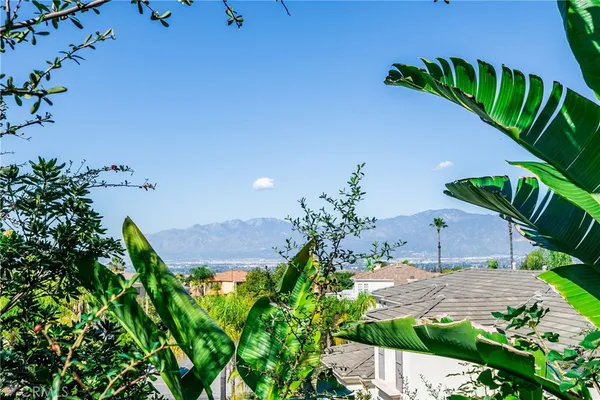 an aerial view of a house with a swimming pool yard and mountain view in back