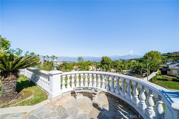 a view of a balcony with wooden floor and fence