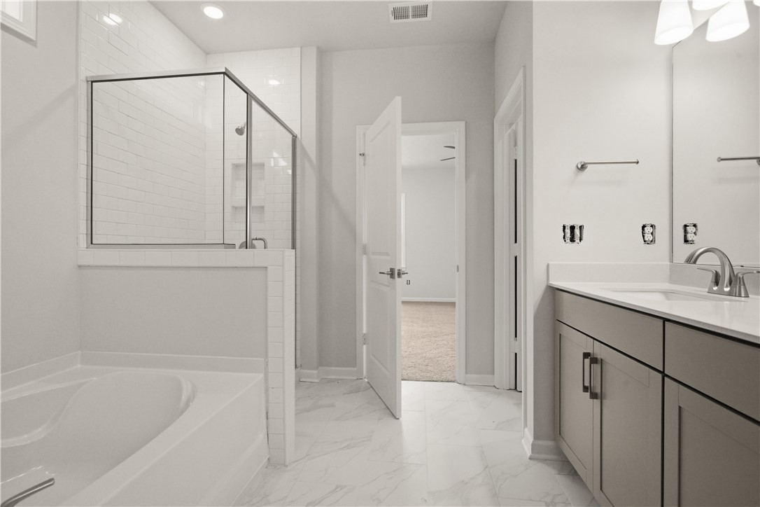552 Hydrangea Street, Unit LOT 66 Seneca, SC 29678 - Photo 17 of 31 Modern bathroom featuring sleek white tiling and a spacious vanity with an undermount sink.