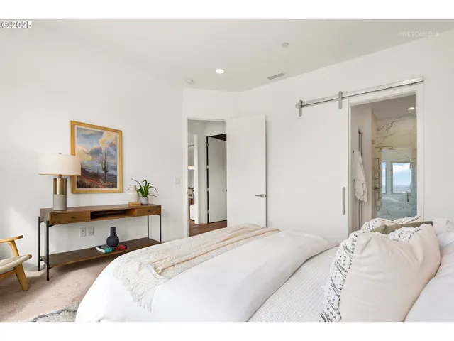 a bedroom with a bed and a lamp